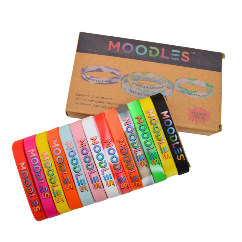 Colorful 'Moodles' wristbands displayed in front of their packaging on a white background.